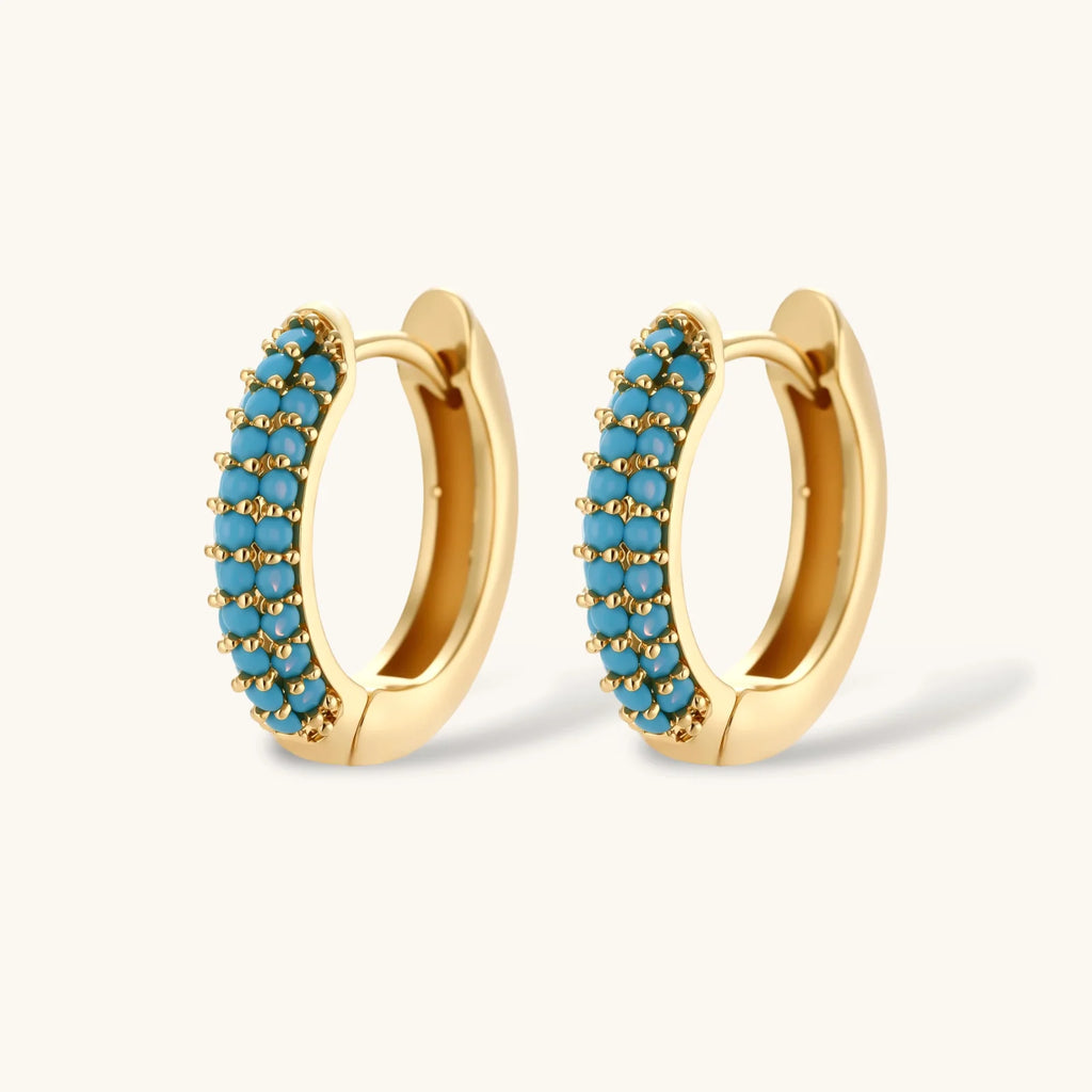 Close-up of the Azure Curve hoop earrings with turquoise-colored stones