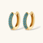 Close-up of the Azure Curve hoop earrings with turquoise-colored stones