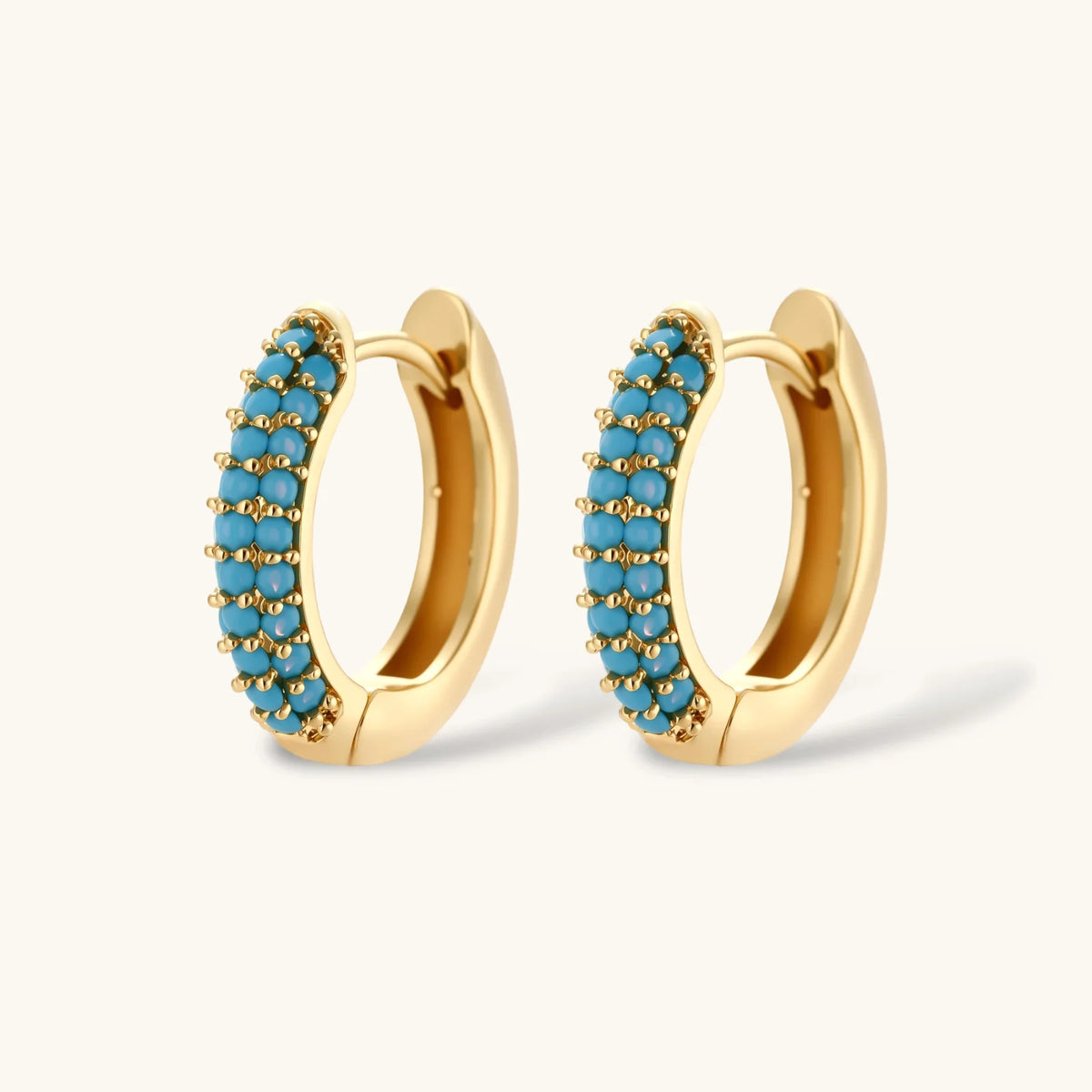 Close-up of the Azure Curve hoop earrings with turquoise-colored stones