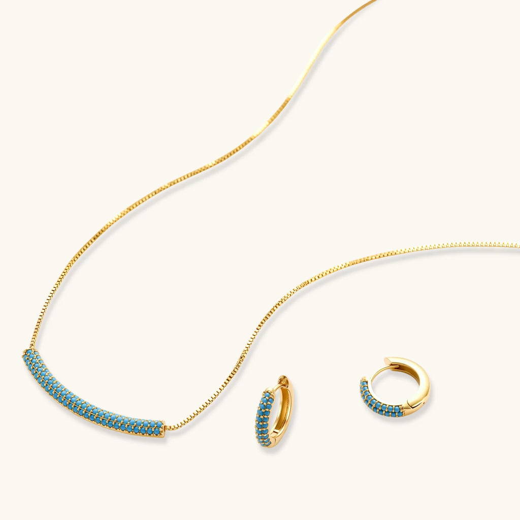 Azure Curve necklace and hoop earrings shown at an angle, with one hoop open