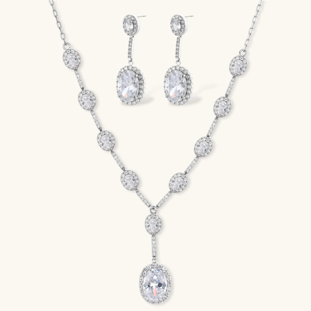 Celestial Cascade set: silver-tone Y-necklace and drop earrings with oval clear stones in halo settings, front view