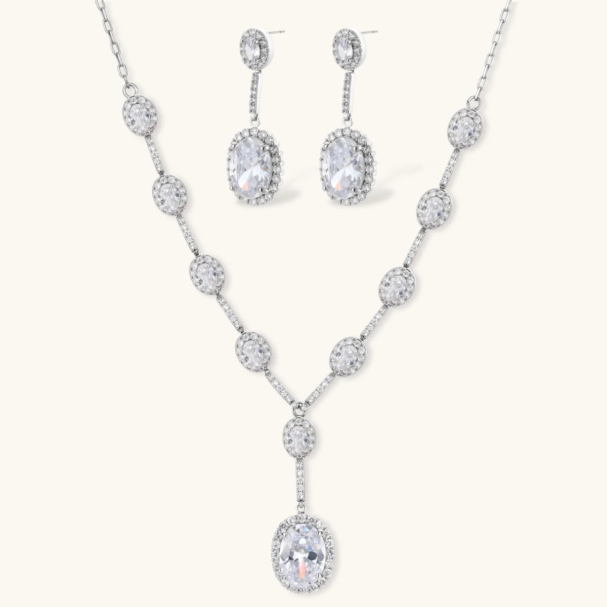 Celestial Cascade set: silver-tone Y-necklace and drop earrings with oval clear stones in halo settings, front view