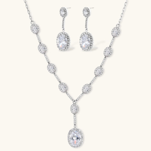 Celestial Cascade set: silver-tone Y-necklace and drop earrings with oval clear stones in halo settings, front view
