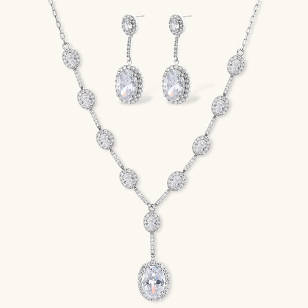 Celestial Cascade set: silver-tone Y-necklace and drop earrings with oval clear stones in halo settings, front view