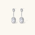Close-up of the Celestial Cascade drop earrings with oval clear stones in halo settings