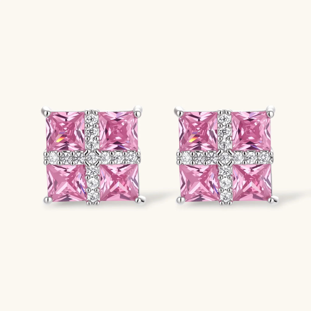 Close-up of the Pink Ribbon Cross square stud earrings with pink stones and a white crossed band
