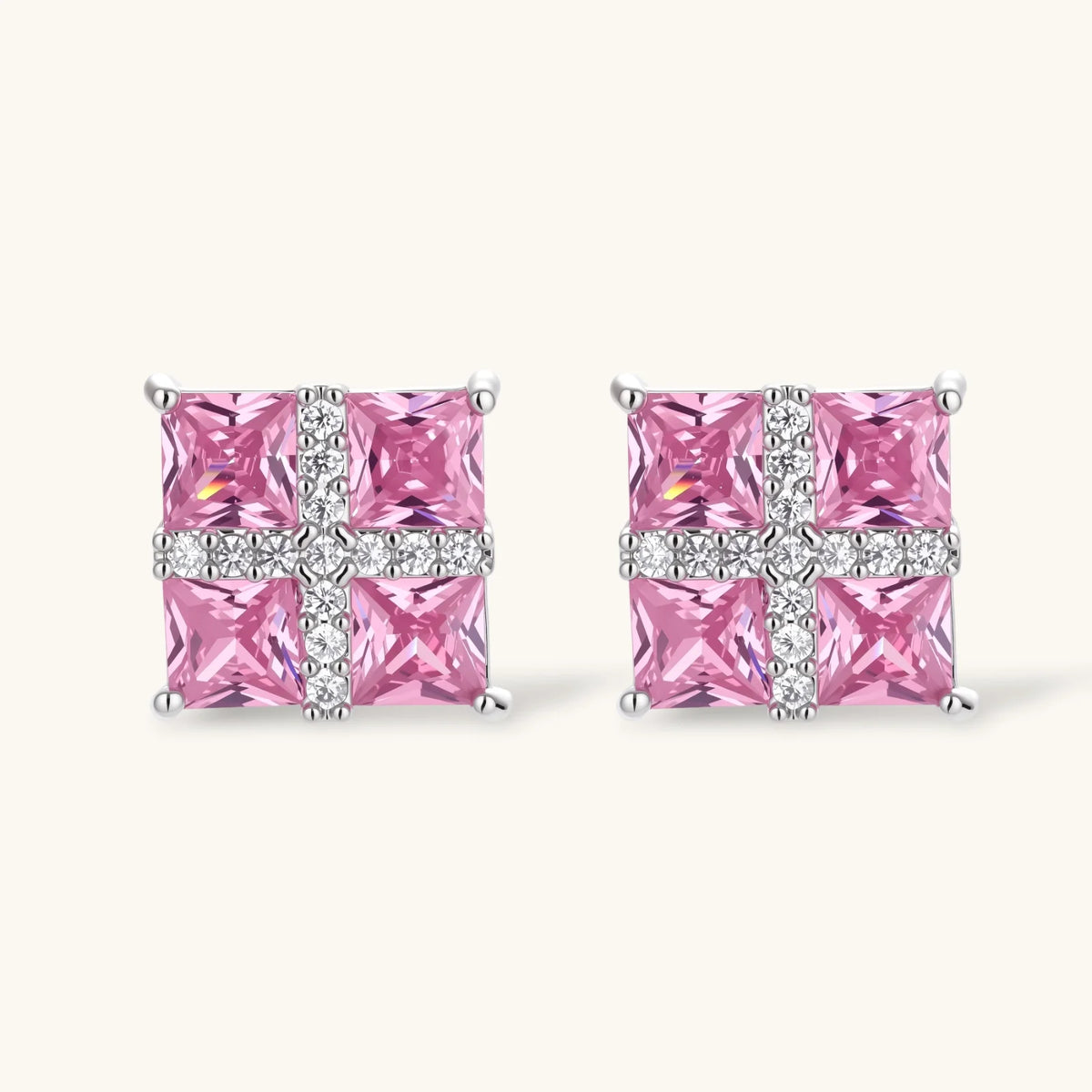Close-up of the Pink Ribbon Cross square stud earrings with pink stones and a white crossed band