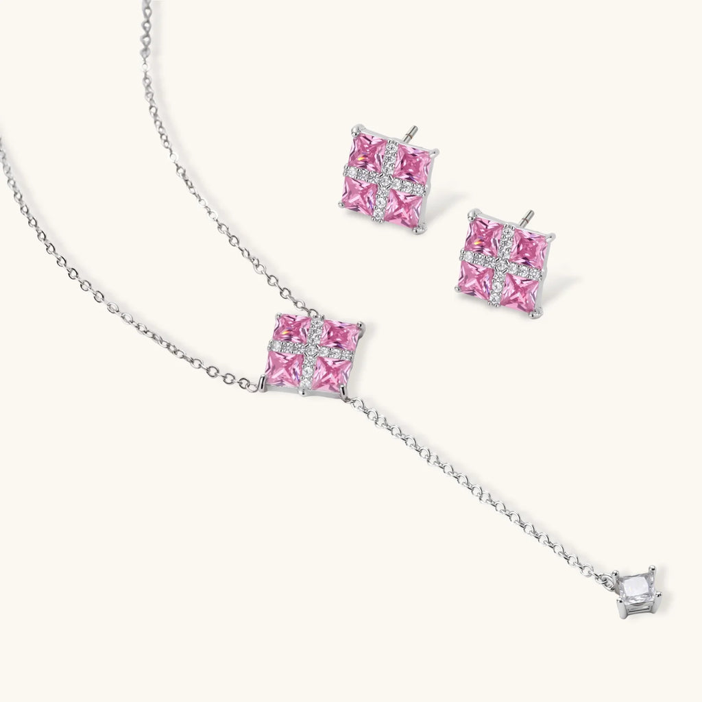 Pink Ribbon Cross necklace and stud earrings shown at an angle