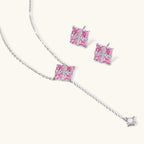 Pink Ribbon Cross necklace and stud earrings shown at an angle