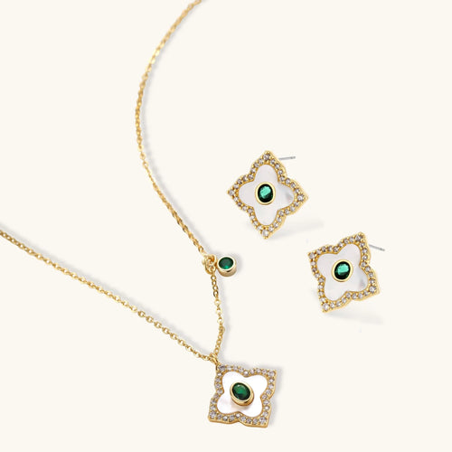 Emerald Bloom pendant necklace and four-petal stud earrings shown at an angle
