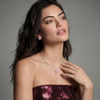 Model in a burgundy top wearing the Pink Ribbon Cross necklace and earrings
