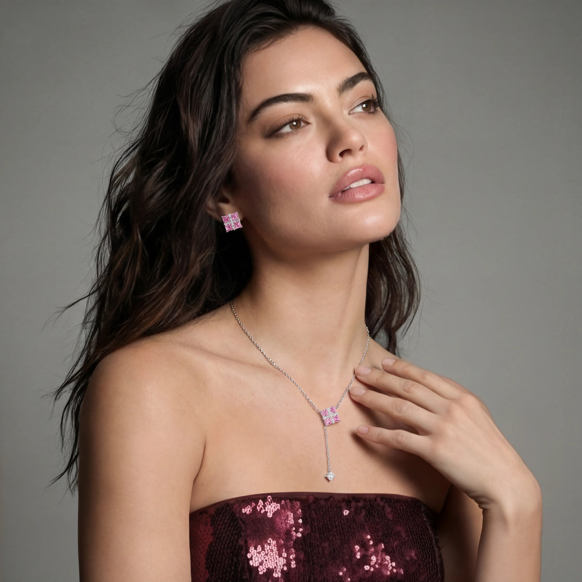 Model in a burgundy top wearing the Pink Ribbon Cross necklace and earrings