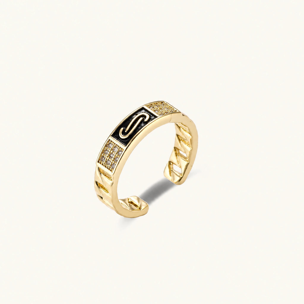 Gold-plated adjustable ring with twisted chain band, central cubic zirconia stone surrounded by crystal halo on cream background