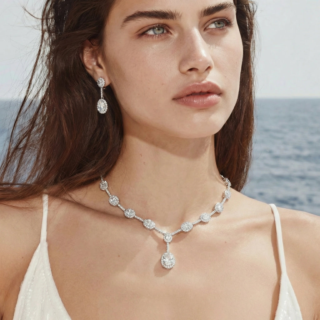 Model by the sea wearing the Celestial Cascade necklace and earrings