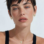 Model in a black top wearing the Emerald Bloom necklace and earrings