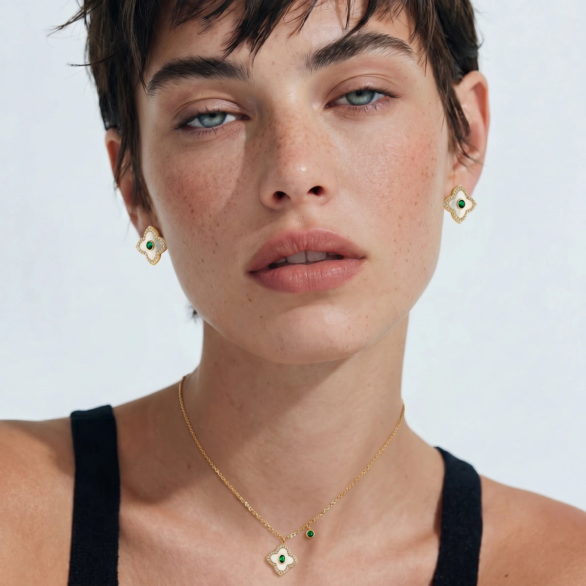Model in a black top wearing the Emerald Bloom necklace and earrings