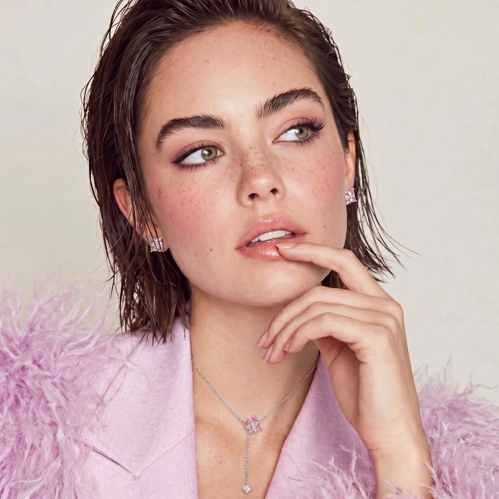 Model in a pink feathered jacket wearing the Pink Ribbon Cross necklace and earrings