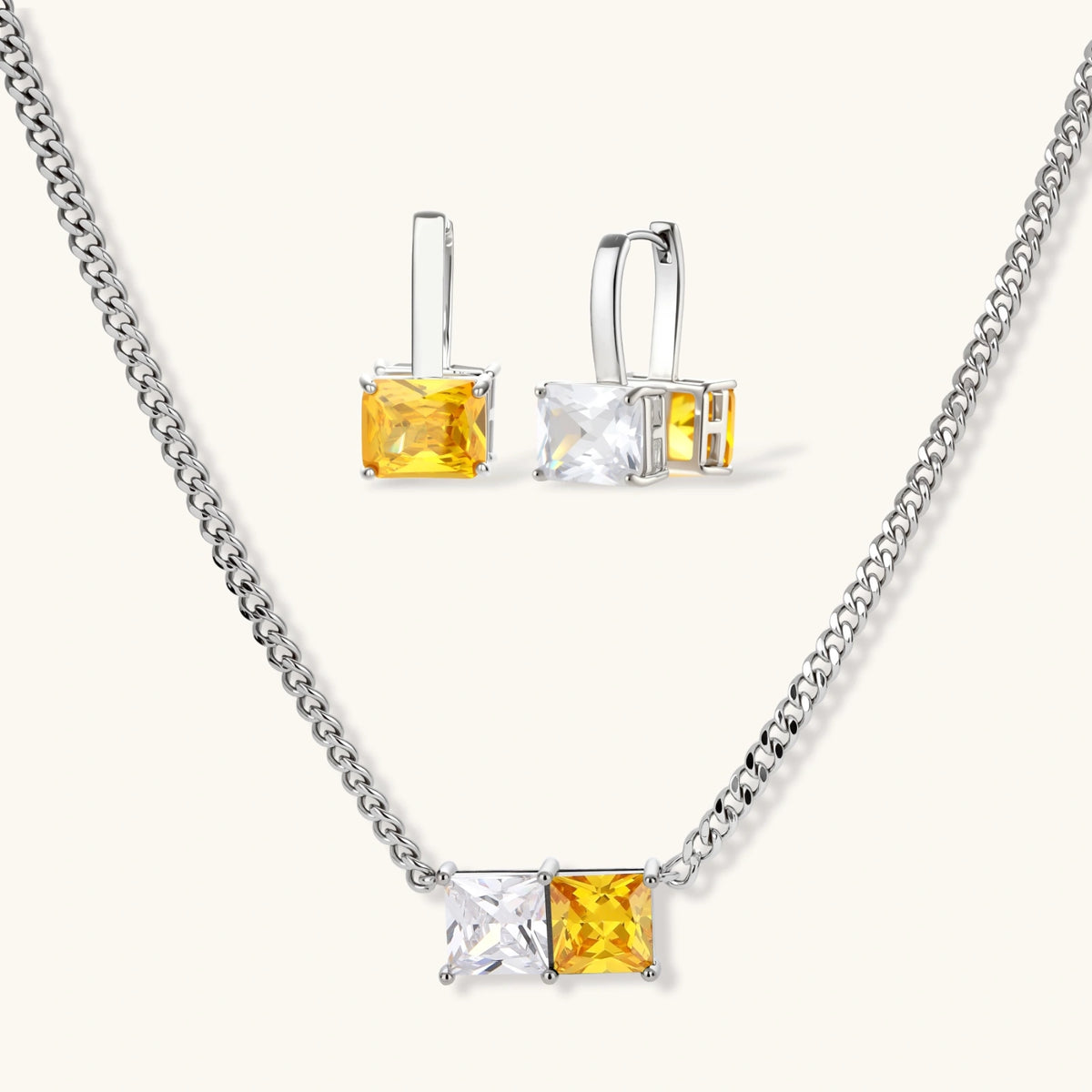 Solar Duo set: silver-tone curb-chain necklace and drop hoop earrings with paired yellow and clear square stones, front view