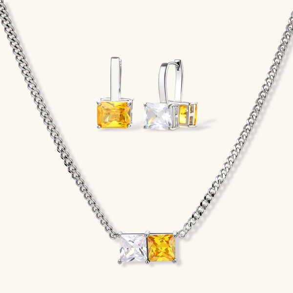 Solar Duo set: silver-tone curb-chain necklace and drop hoop earrings with paired yellow and clear square stones, front view