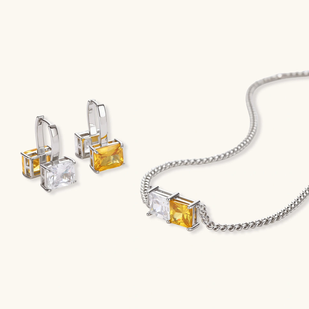 Solar Duo necklace and drop hoop earrings shown at an angle