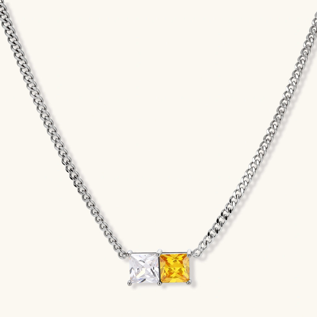 Solar Duo curb-chain necklace on its own, with a pendant of paired yellow and clear square stones