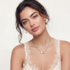 Model in a lace top wearing the Solar Duo necklace and earrings